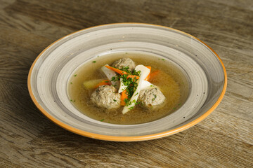 Goose soup, consommé with dumplings and vegetables