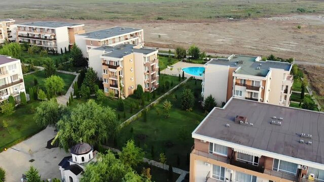 Panoramic aerial view of architectural complex of new residential houses in Bulgaria on Sunny Beach. Hotels and apartments with swimming pool. Summer holiday in Europe. Aerial photography, drone view.