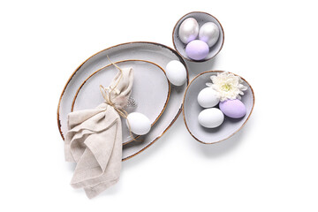 Beautiful table setting with Easter eggs and chrysanthemum flower on white background