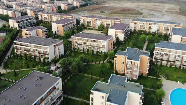 Panoramic aerial view of architectural complex of new residential houses in Bulgaria on Sunny Beach. Hotels and apartments with swimming pool. Summer holiday in Europe. Aerial photography, drone view.