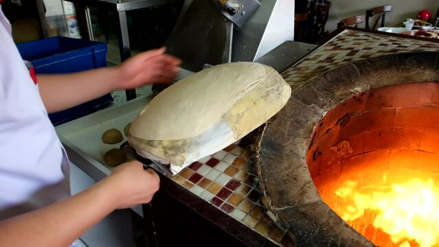 Making Pita Bread, Arabic Bread, Syrian Bread, Arabic Khubz, Indian Flat Bread in Tandoor. 