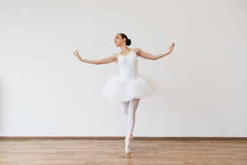 Woman in tutu motion, balance flexibility concept, lifestyle. Beautiful young female ballet dancer...