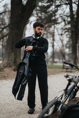 Fototapeta premium A focused businessman with headphones pauses beside his bike in a serene park setting, reflecting on the day.