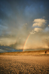 Rainbow over beach in Denmark after rain. High quality photo