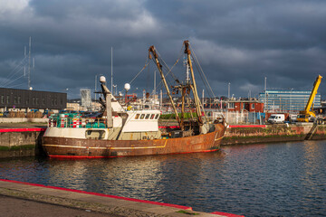 Fototapeta premium A fishing boat moored on the quayside in the port of Le Havre in France