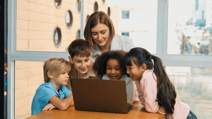 Cute african girl programing system while surround with caucasian teacher and diverse friend....