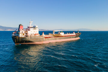 Petroleum tanker vessel or cargo ship carrier waiting loading petrochemical oil product on refinery...
