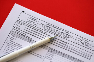 Indonesian tax form notification letter SPT for income tax period article 23 and or article 26 on accountant table