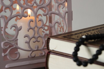 burning candle in censer. quran and tasbih. prayer and Ramadan.