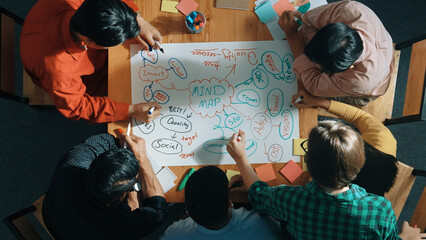 Top down view of business team working together by using mind map brainstorming idea and sharing...