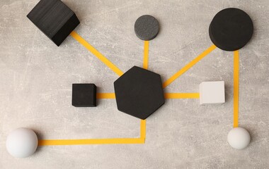 Business process organization and optimization. Scheme with geometric figures on light grey table, top view