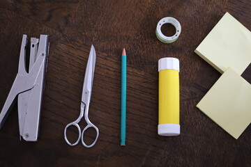 wooden flatlay of office and school homework supplies