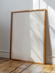 Blank White Canvas with Wooden Frame on Floor by Wall
