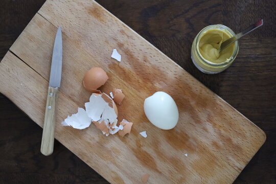 boiled eggs on a wooden cutting board, top view