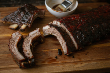 sliced barbeque spare ribs on wooden board