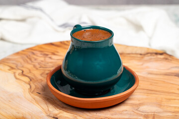 Turkish coffee. Traditional Turkish cuisine flavors. Freshly brewed Turkish coffee on a wooden background. This coffee is very famous in middle east and turkey