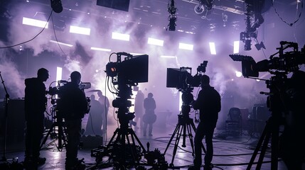 a group of people standing around a camera set up in a room with smoke