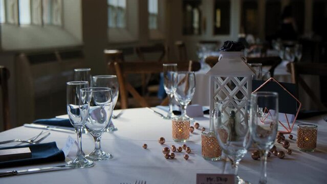 Venue banquet table set up served dinner tableware and silverware on wedding event. Move camera footage. Close up