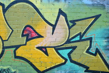 Colorful background of graffiti painting artwork with bright aerosol outlines on wall. Old school...