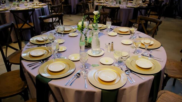 Venue banquet table set up served dinner tableware and silverware on wedding event. Move camera