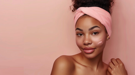 Beautiful young afro american woman with pink headband and clean fresh skin, on beige, pink background with copy space, facial skin care. Cosmetology, beauty, spa. female cosmetics concept