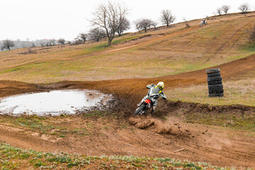 Riding a dirt bike on a motocross track with highland grass