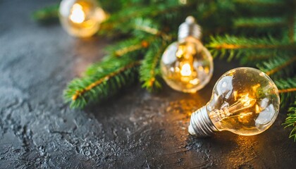 christmas light bulbs with fir branches on a dark shale background