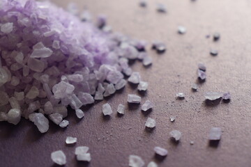 coarse lavender sea salt for bath on purple background