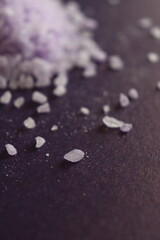 coarse lavender sea salt for bath on purple background