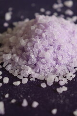 coarse lavender sea salt for bath on purple background