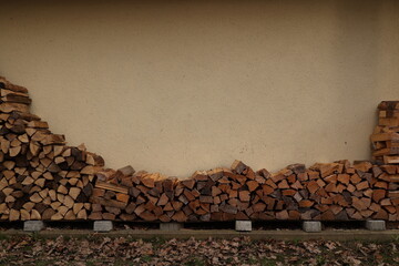 A pile of wood stacked against a wall - 751003911