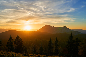 A beautiful sunset in the Alpine mountains. Forest, Alpine peaks, Austria, Europe.