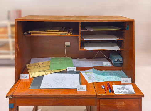 ikebukuro, japan - jan 16 2024: A japanese animator desk exhibited at the free museum of the Anime Tokyo Station featuring all the steps of the creation of the creation of an anime with Astro Boy.