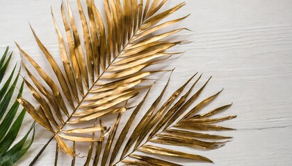 gold tropical palm leaves on white background flat lay top view minimal concept