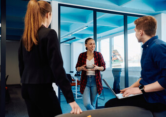 A diverse team of young business people exchanging ideas in a modern startup office