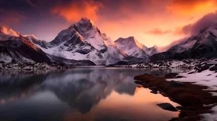 Fototapeten Panoramic view of snowy mountains reflected in a lake at sunset © Iman