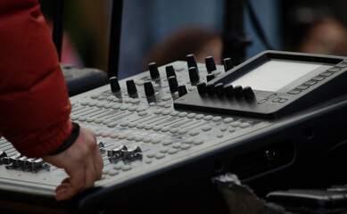 sound engineer operating audio console at live recital
