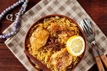 Halal Chicken Biryani with Spices and Lemon for Ramadan Iftar, Top View, Copy Space