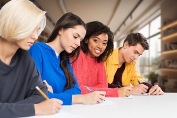Happy students study together during class.