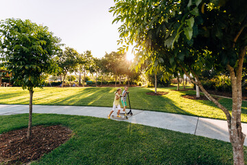 Children playing on scooters in park