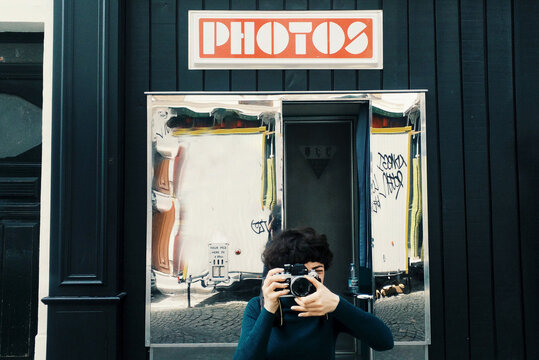 A photographer taking photos in front of photobooth