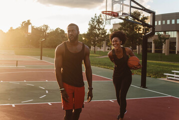 African American Couple playing basketball