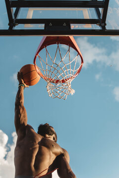 Young African American man playing basketball