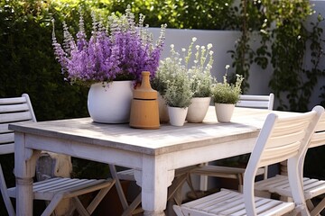 Fototapeta na wymiar Mediterranean Nordic Twist: Lavender Planters and White Chairs on Wooden Table