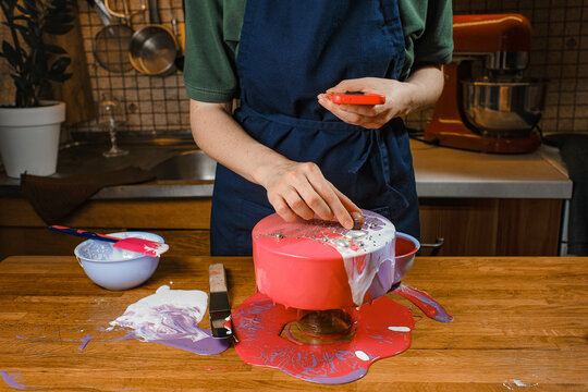 pastry chef decorates his mousse cake and shoots it on a smartphone