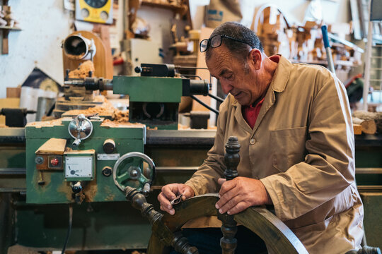 Craftsman sanding wooden steering wheel