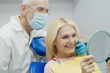 Dental doctor treating a female patient in hospital.