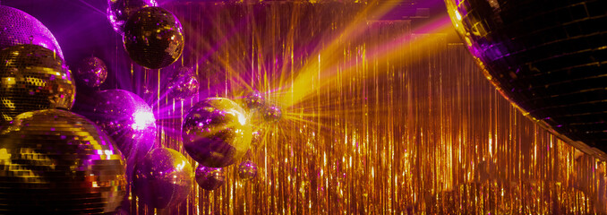 abstract disco background with mirror balls and colored rays of light