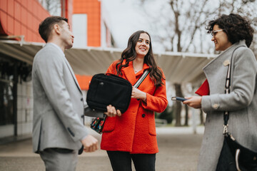 Three business professionals engaging in a discussion outdoors with digital tablets and documents in hand.