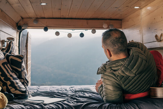 Man enjoying the view from a camper van